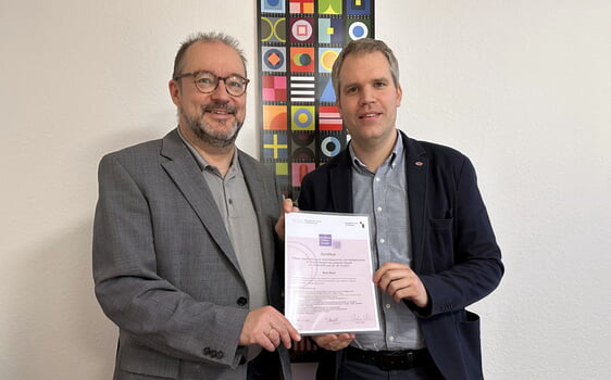 Sören Meyer (r.) ist neuer Multiplikator im Schulungsteam zur Prävention gegen sexualisierte Gewalt. Nach erfolgreichem Abschluss der Fortbildung bekam Meyer das entsprechende Zertifikat Christof Grote, Superintendent des Evangelischen Kirchenkreises Lüdenscheid-Plettenberg überreicht (Foto: EKKLP)