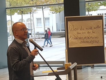 Herr Ostermann, Leiter der Adolph-Kolping-Grundschule spricht zu den Teilnehmern des Friedensgebets 2018