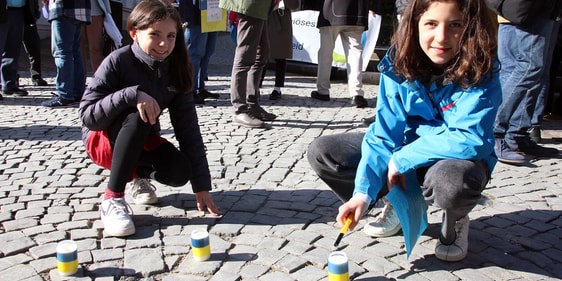 Kinder entzündeten nahe des Engels der Kulturen auf der Wilhelmstraße Kerzen in den Farben der Ukraine. (Foto: Jakob Salzmann)